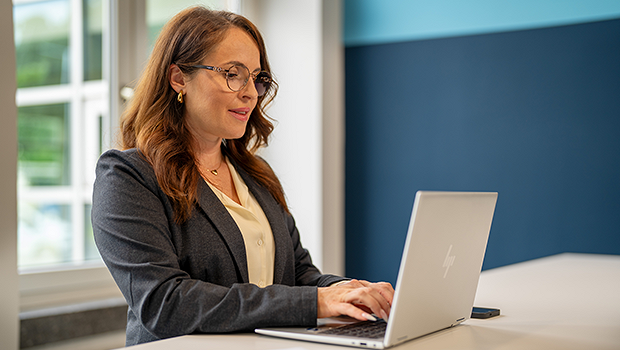 A woman is working on a laptop