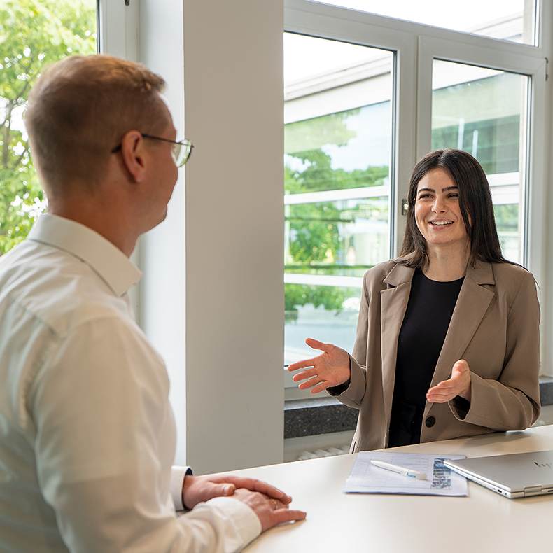 A young woman is providing information to an applicant