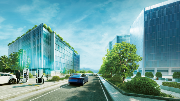 Modern buildings with green roofs, a street with cars driving by, and a car parked at a charging station on the roadside